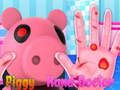 Logħba Piggy jittratta idejh  onlajn