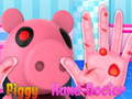 Logħba Piggy jittratta idejh  onlajn